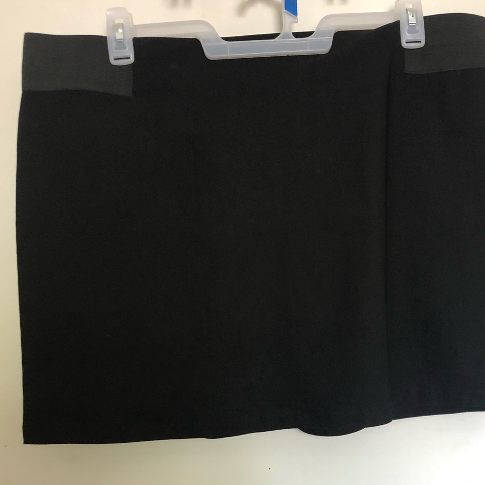 Plus size black mini skirt with elastic waistband.